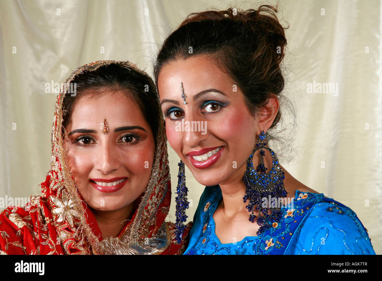 Asian women in Traditional Indian Wedding Dresses with jewellery, earrings, tikka and bindi Stock Photo