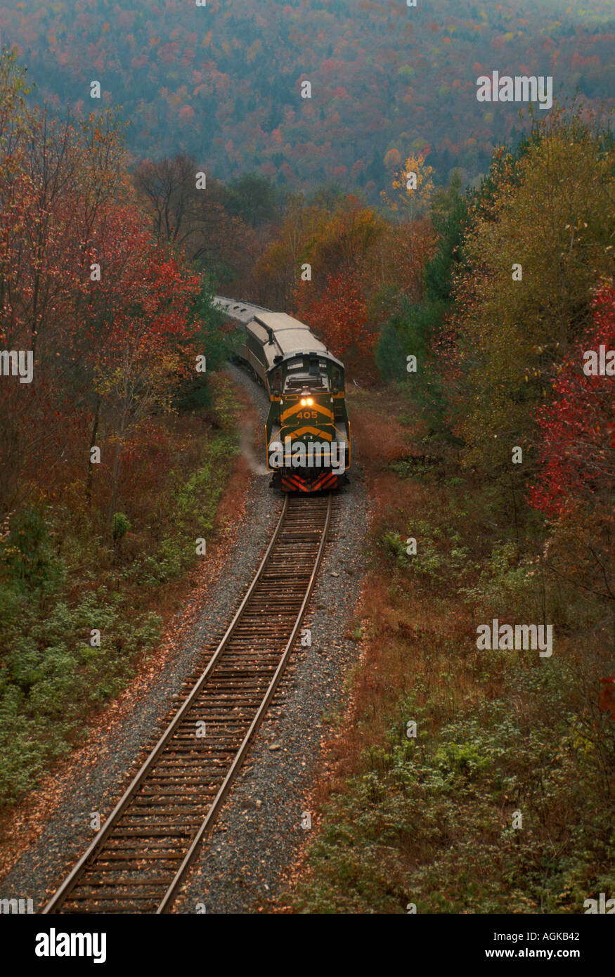 The mountain train: Evening train rounds the bend in New England fall countryside, Vermont USA Stock Photo