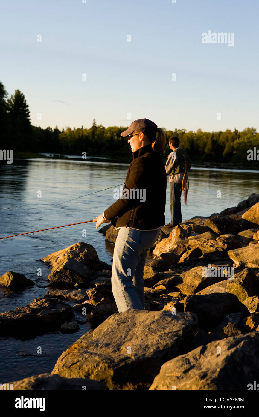 A couple fly fishing on the Moose River in Rockwood Maine USA Stock