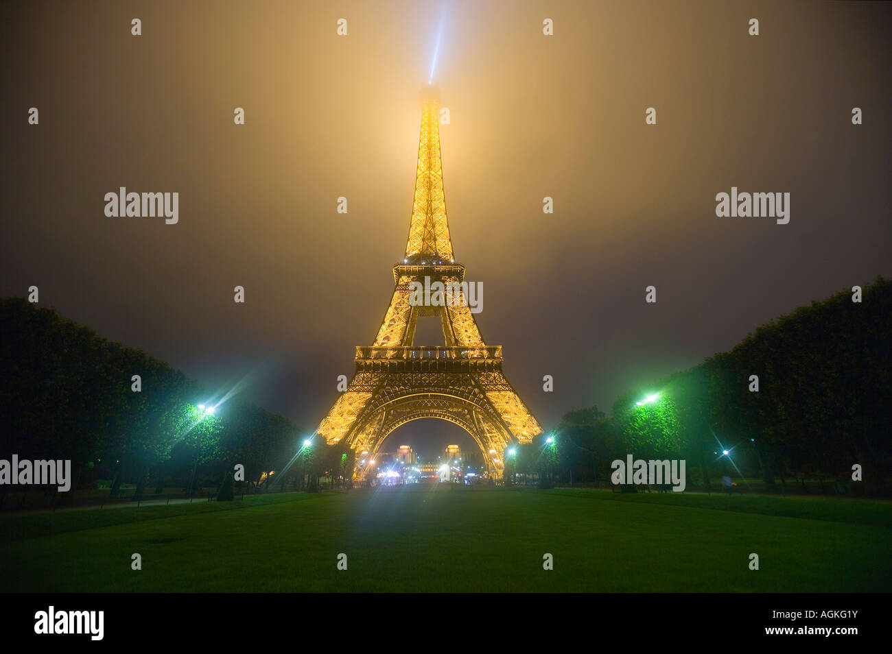 France, Paris. Eiffel Tower illuminated in fog and rain at night. Stock Photo