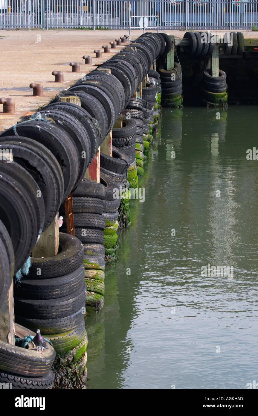 Tyres along the harbour wall at Lowestoft Suffolk England Stock Photo