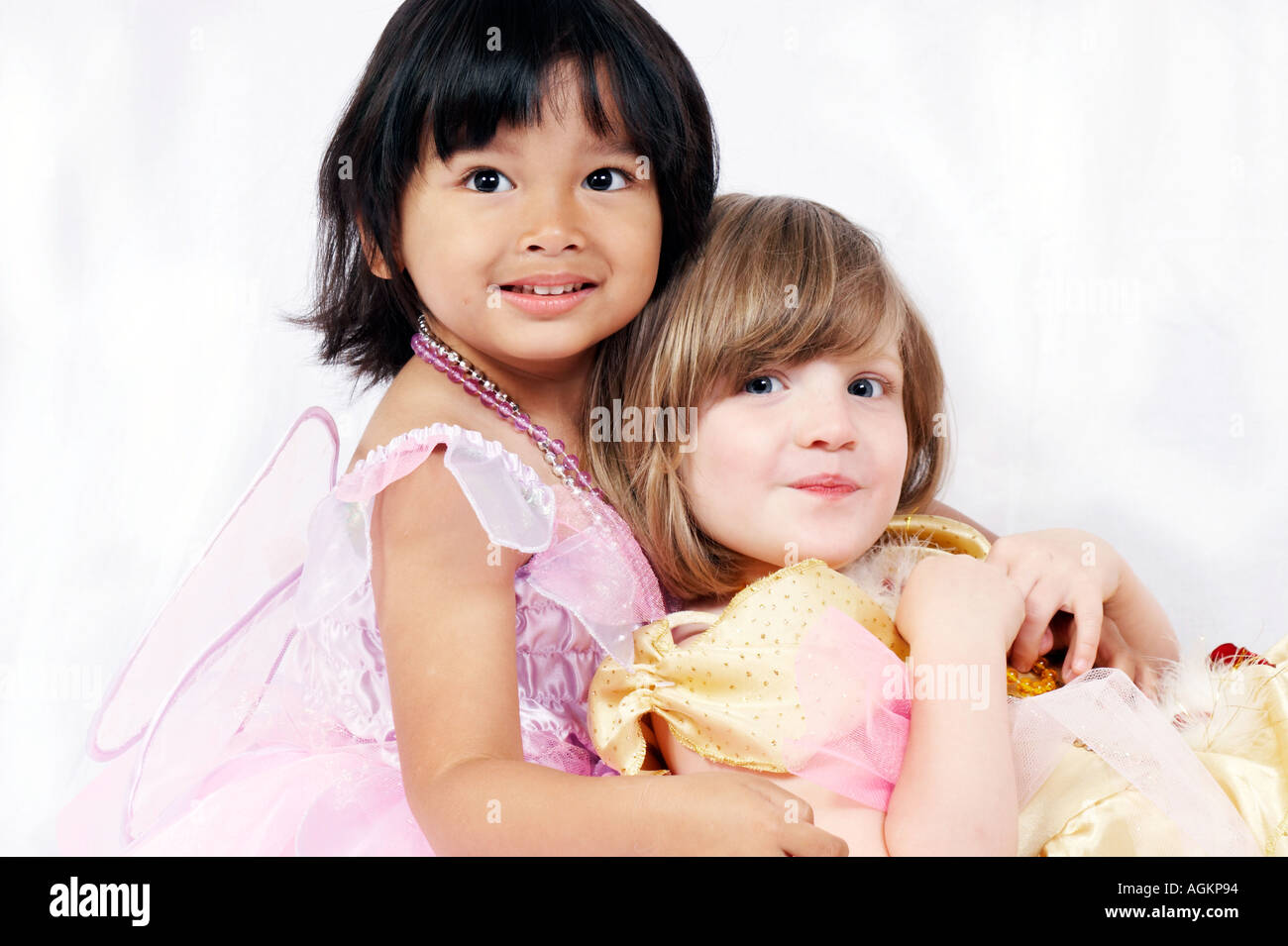 two little girls different ethnic white background Stock Photo