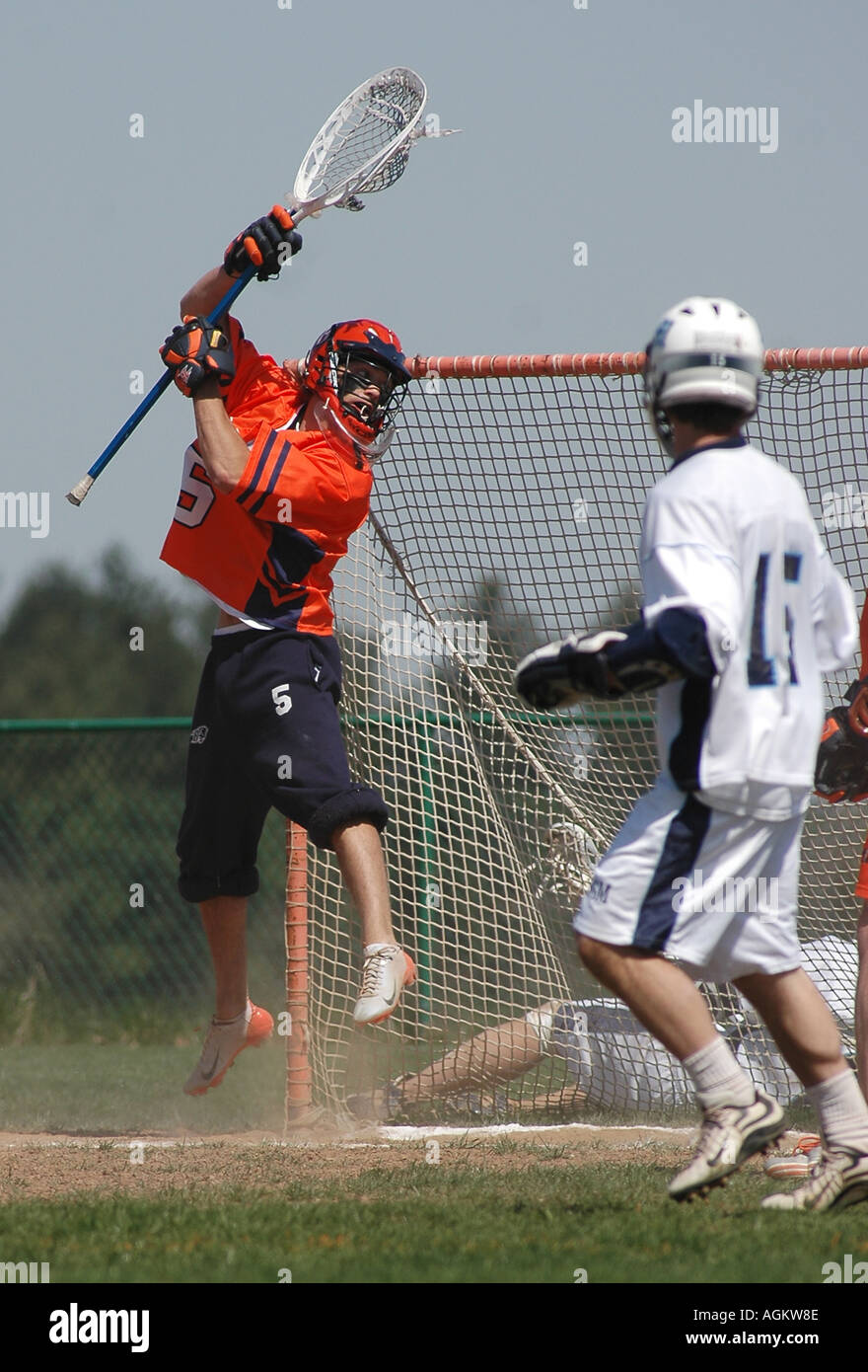 Mens college lacrosse goalie jumps for ball Stock Photo Alamy