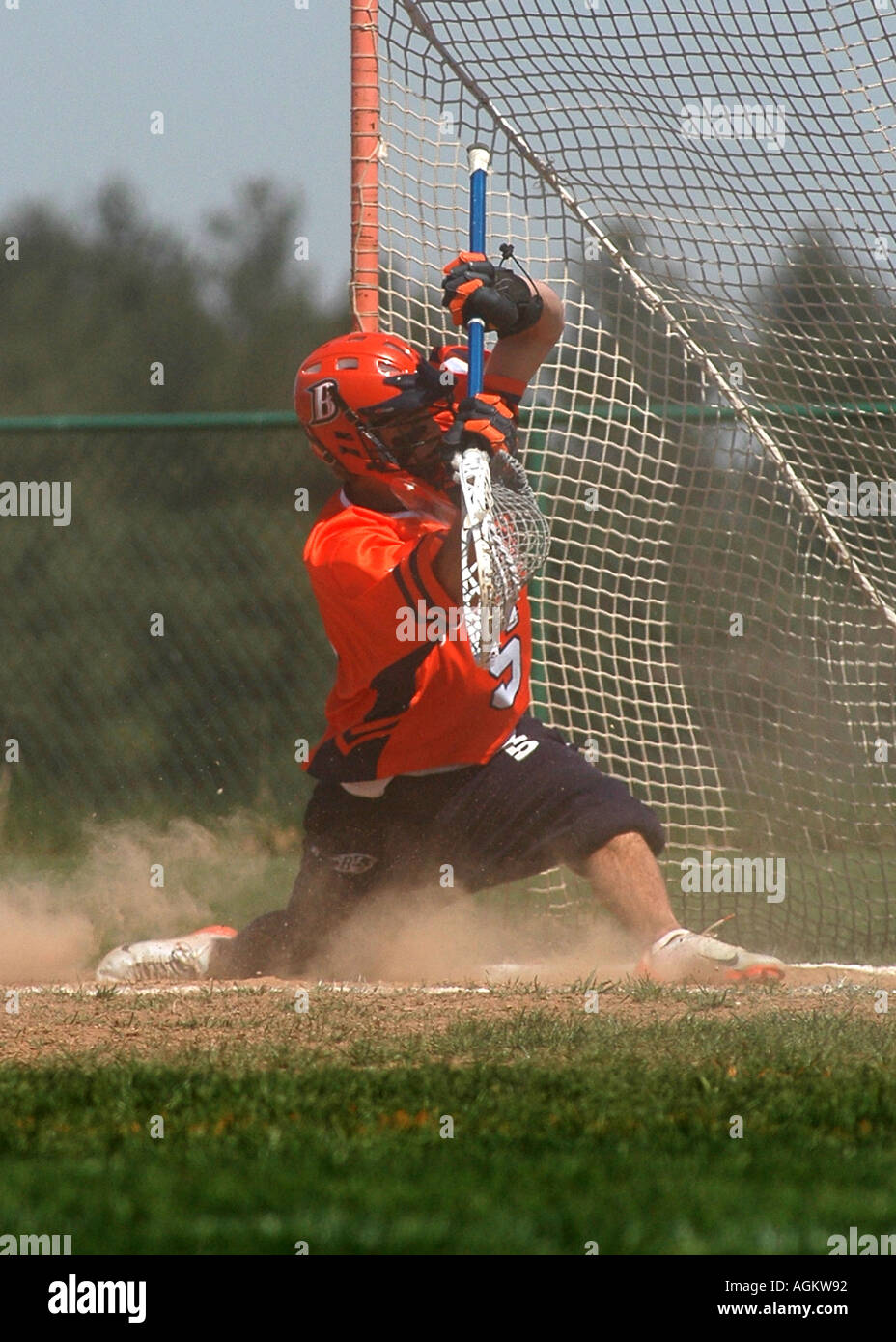 Mens college lacrosse goalie dives for ball Stock Photo Alamy