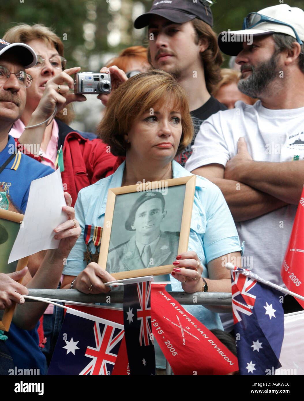 A woman holds a photograph of her lost father during the annual ANZAC day parade in Sydney 25th April 2005 ANZAC day commemorat Stock Photo