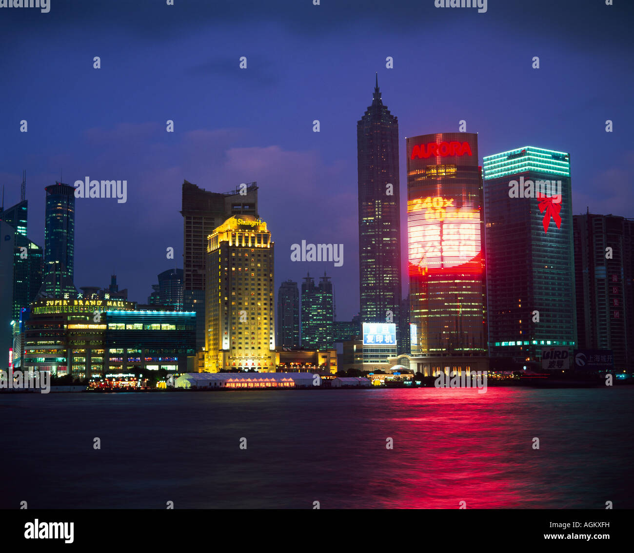 View across river at dusk to the new Pudong district skyline Huangpu River Shanghai China Asia Stock Photo
