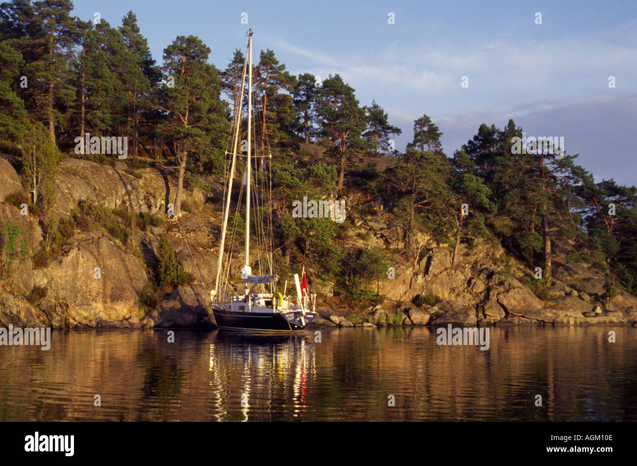 A British flagged Contessa 32 moored in the scandinavian style anchored by the stern among the Swedish archipelago Stock Photo