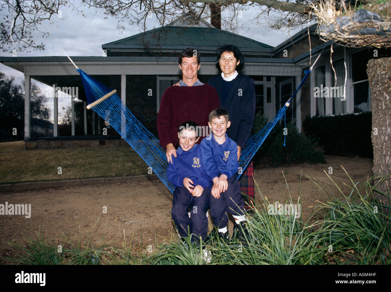 Cowra New South Wales Australia Family Outside Home Children Sitting On Hammock Stock Photo