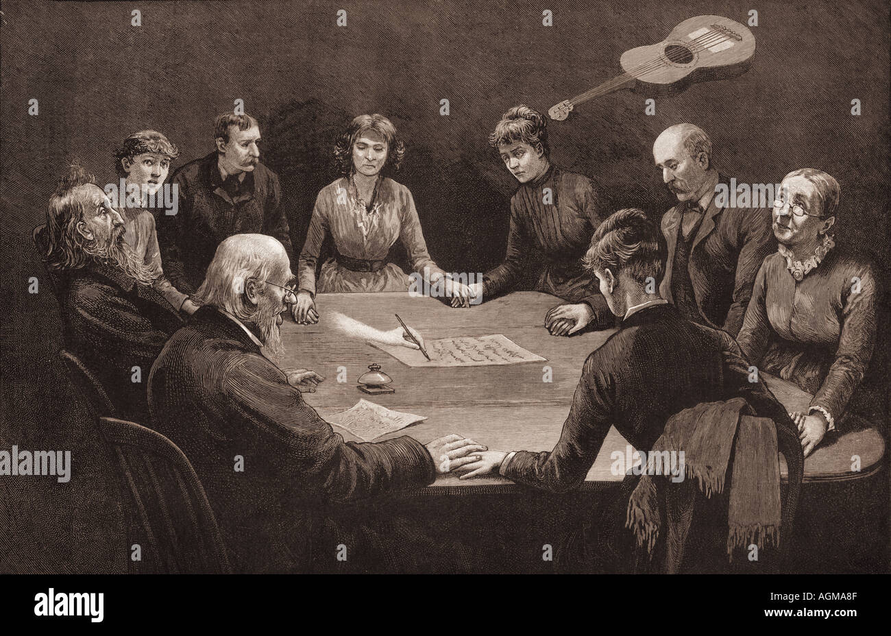 People at a seance appear to experience a guitar floating above their heads and a ghostly hand writing on paper, circa 1887. Stock Photo