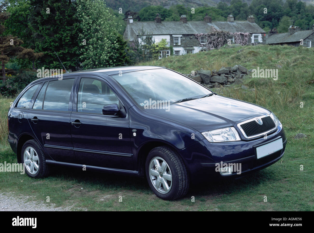 Skoda Fabia Parked on Grass in Front Of Cottages Stock Photo