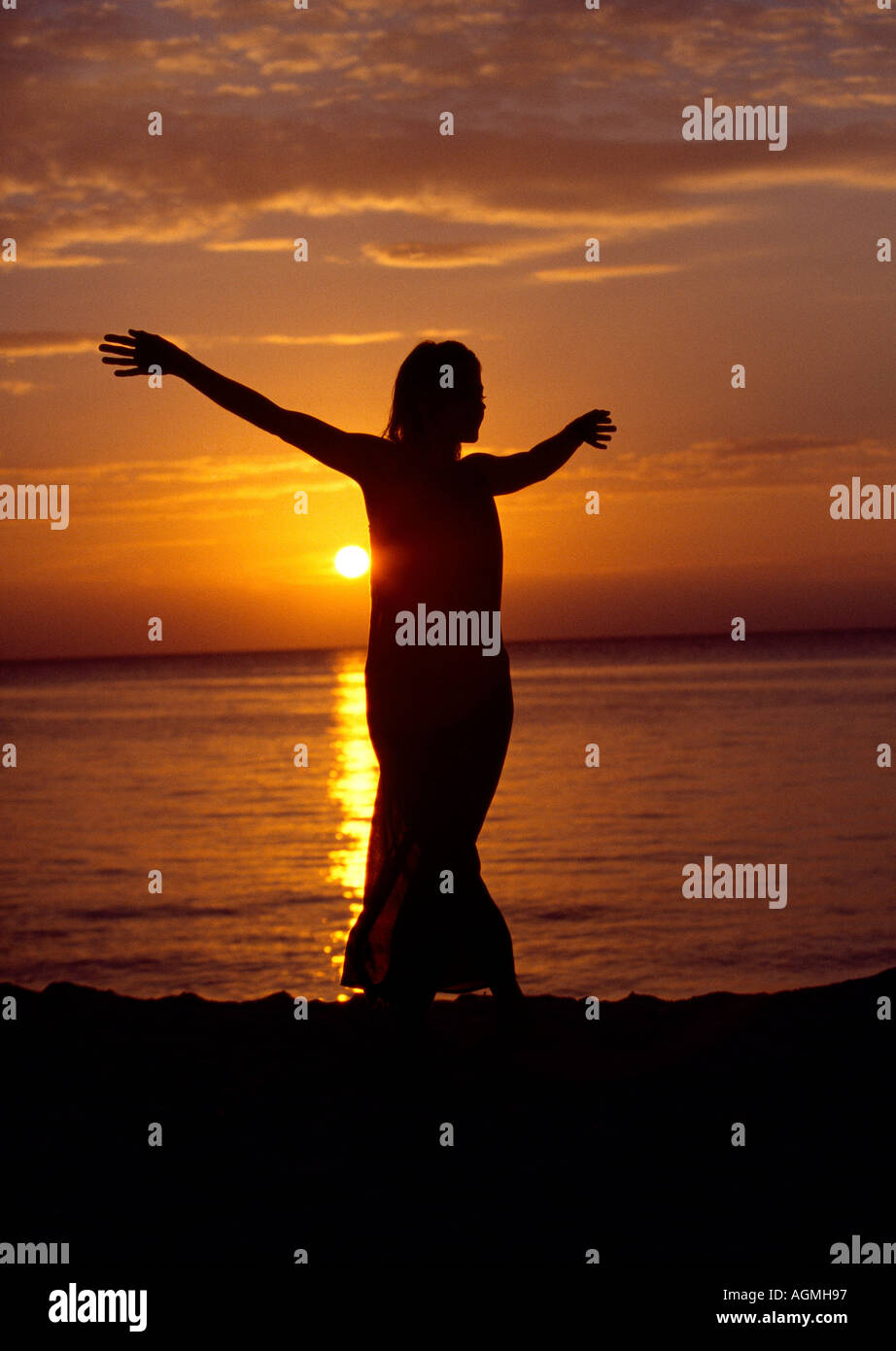 Mexico Cozumel woman in black dress in late afternoon on beach at Nachi Cocom Stock Photo