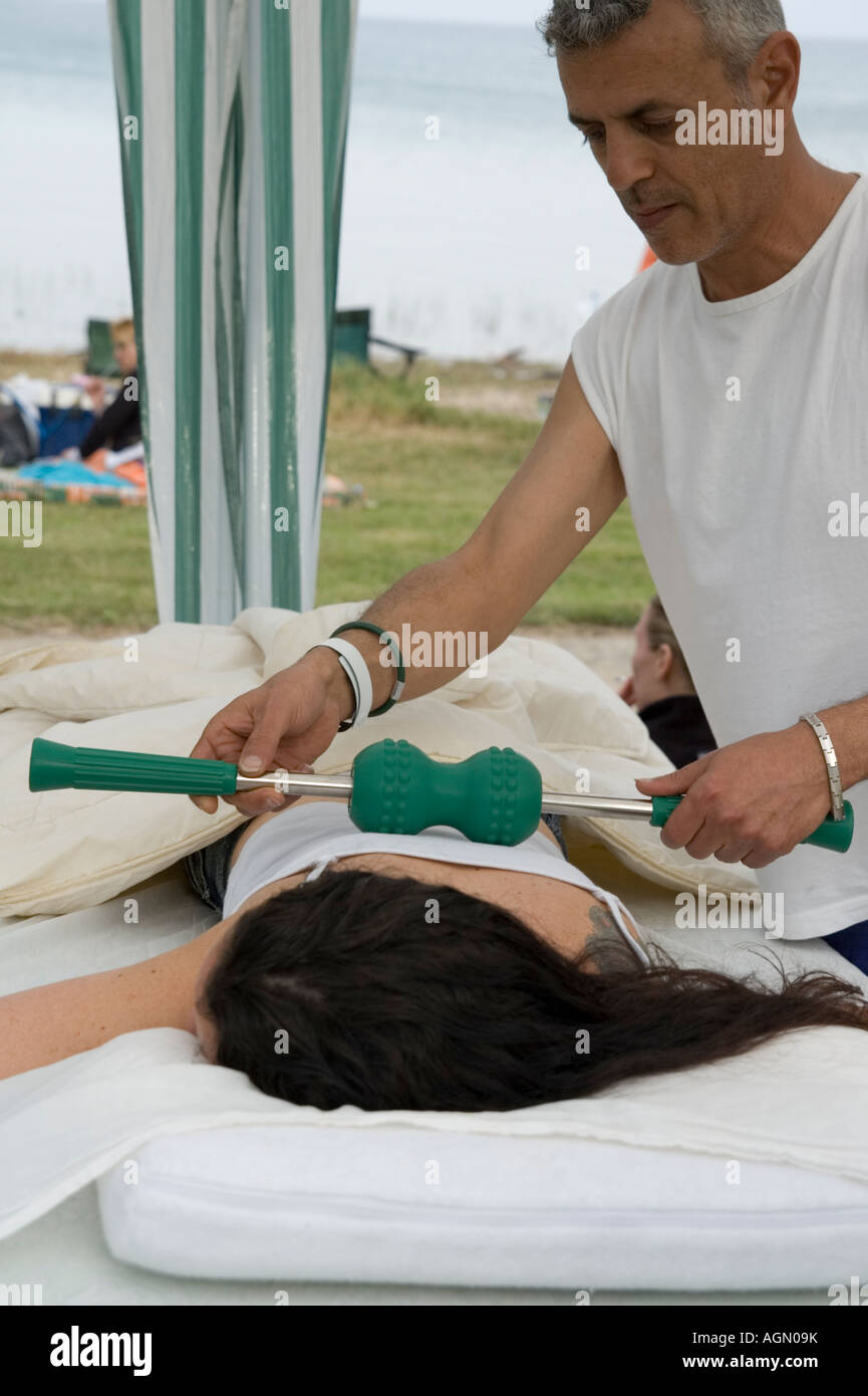 Female receiving a Soothing relaxing massage by male therapist with the aid  of a MagCreator by Nikken Stock Photo - Alamy