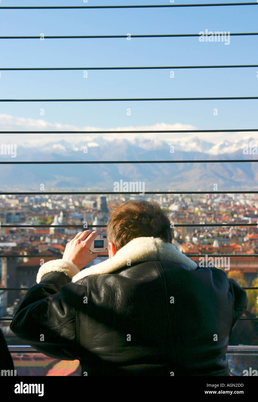 Tourist with camera looking from Mole Antonelliana view point over