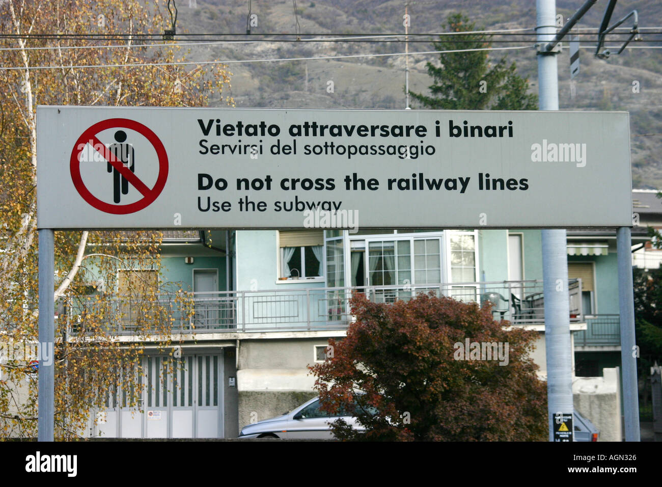 Warning sign Danger high voltage Do not cross railway line Vietato attraversare i binari Italy Stock Photo