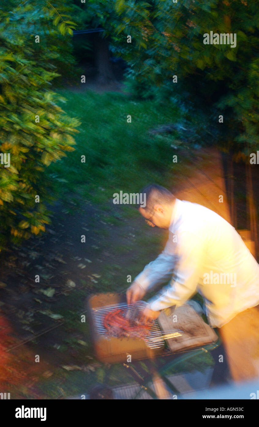 Man working on a barbecue Stock Photo