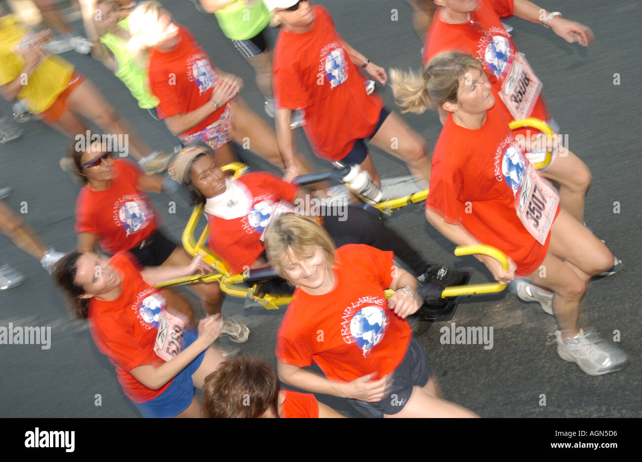 runners carrying handicapped Stock Photo