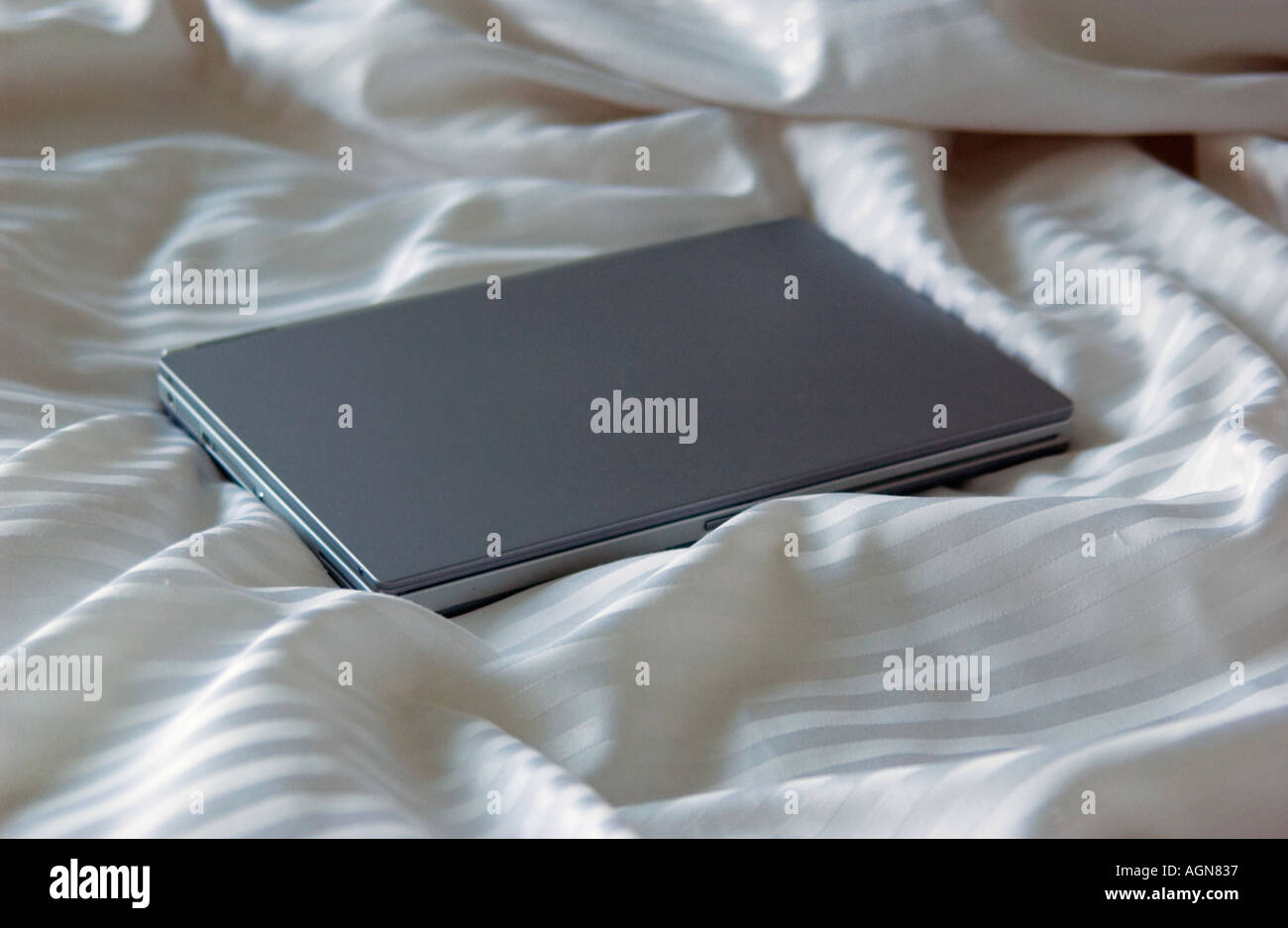 Laptop on a bed Stock Photo Alamy