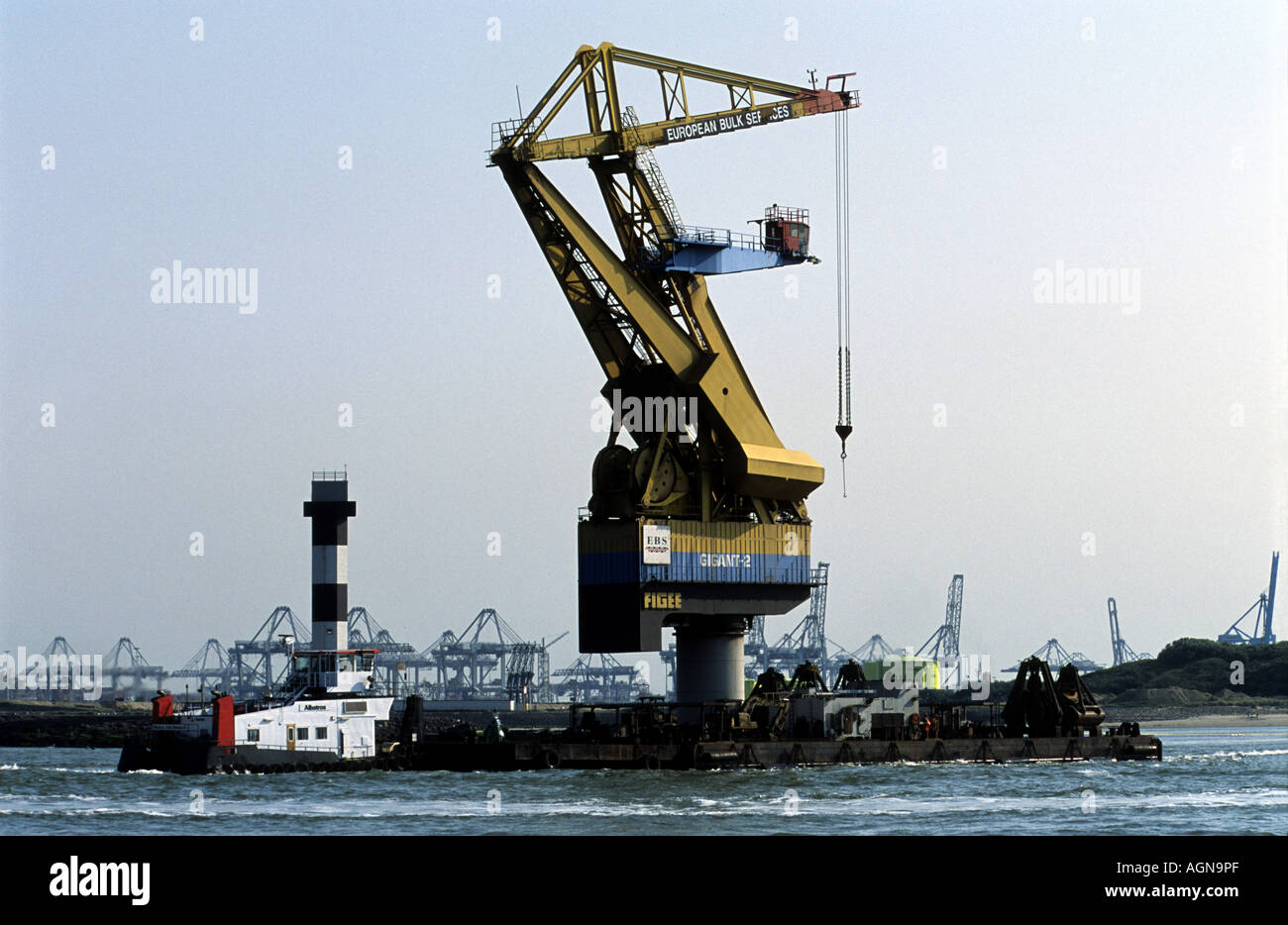 A crane being transported by barge, port of Rotterdam, Holland. Stock Photo