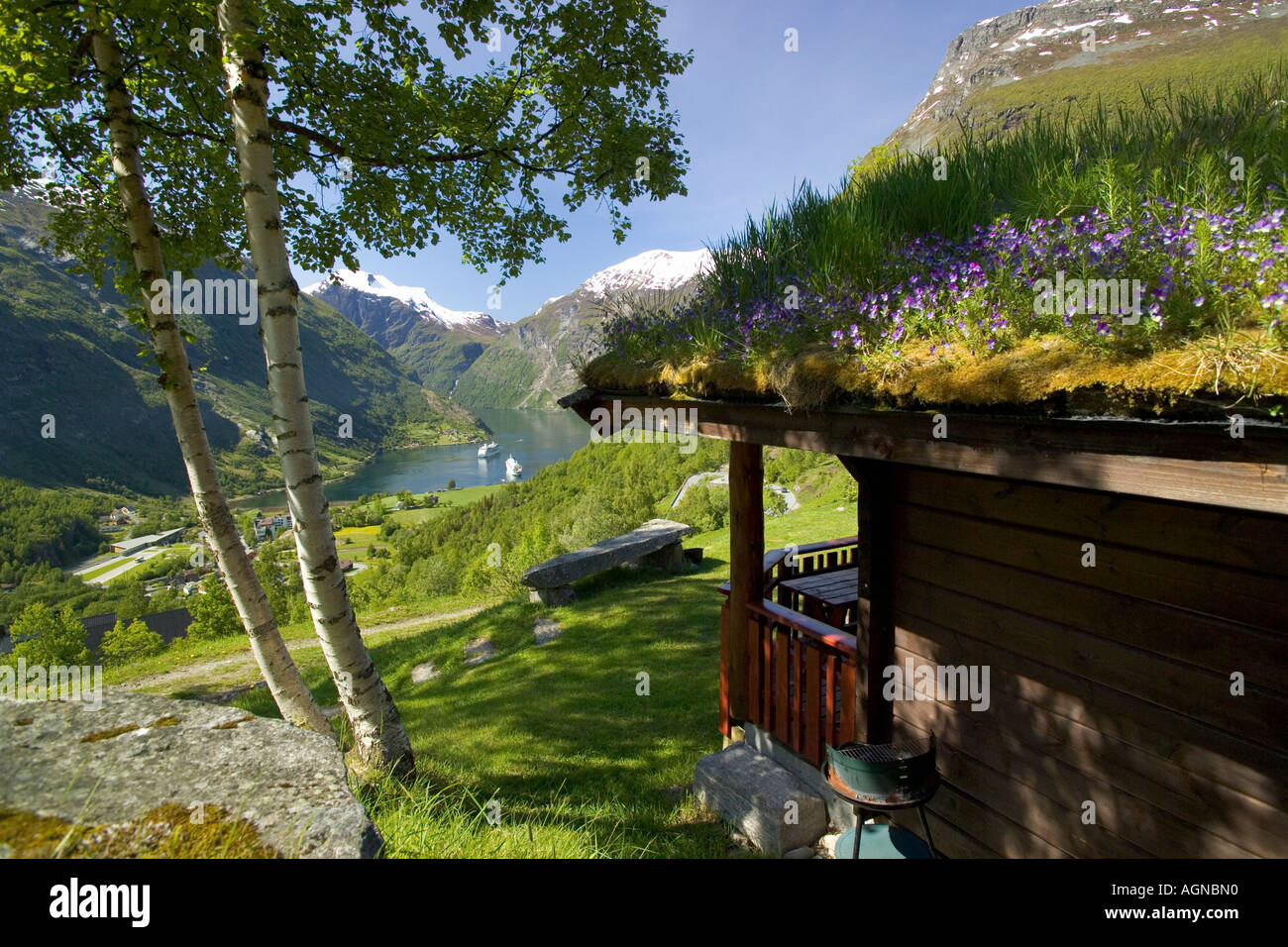 View of the Geirangerfjord from a vacation cabin with grass roof Geiranger Norway Stock Photo