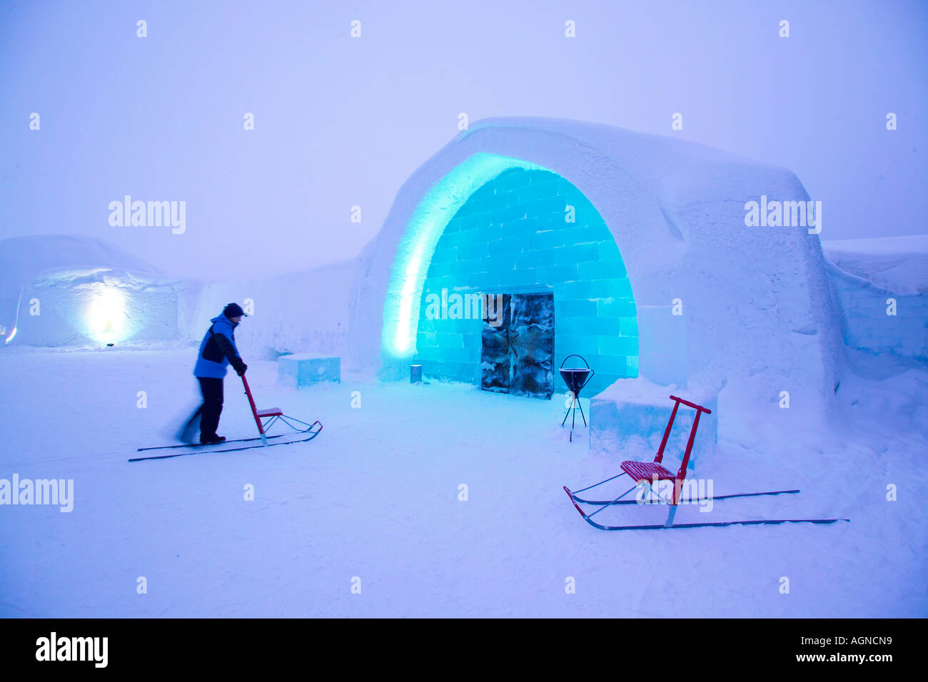 Person using a kicker outside the main entrance of the Ice hotel Jukkasjarvi Sweden Stock Photo