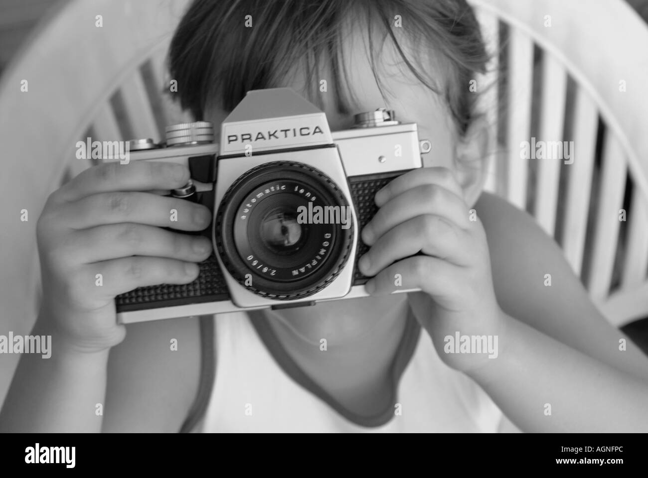 Model Released: Black and White Portrait of a five year old cute girl with a photo camera Nano Calvo VWPics com Stock Photo