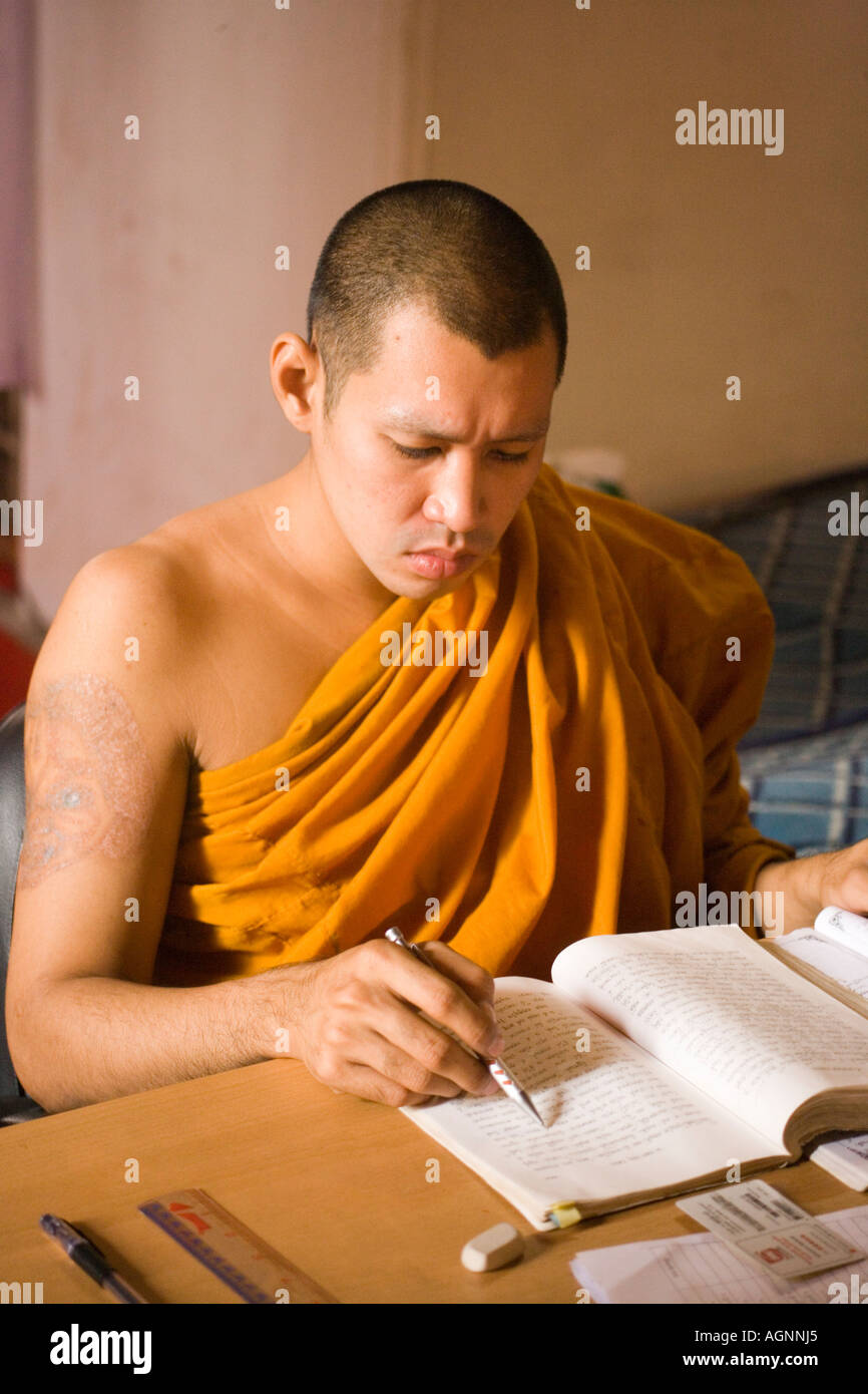 Young Buddhist monk studying Wat Mahathat Ko Ratanakosin Bangkok Thailand Stock Photo