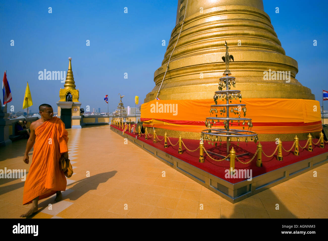 Monk visiting gilded Chedi housed a Buddha relic of the Wat Saket on the Golden Mount Bangkok Thailand Stock Photo