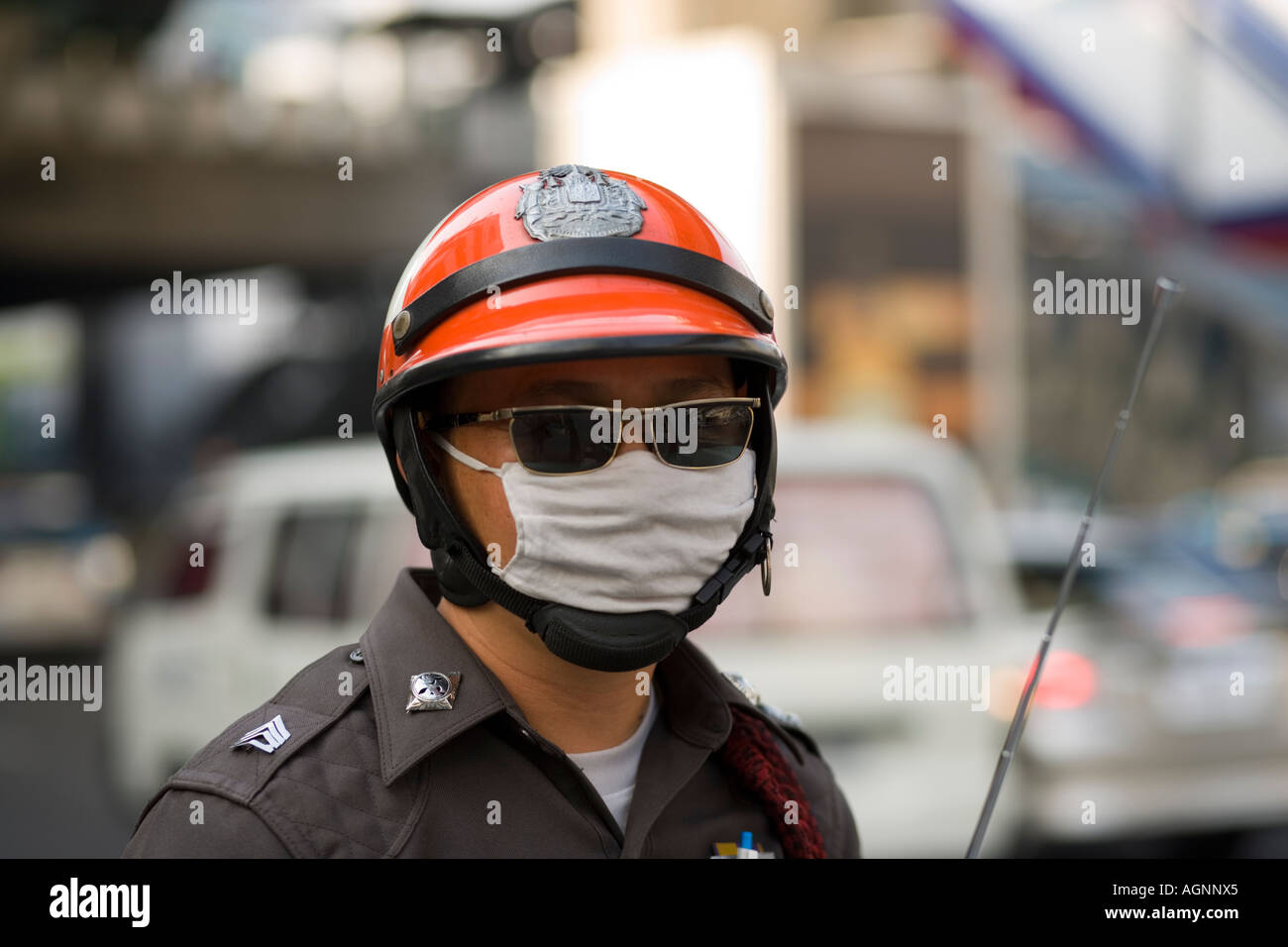 Policeman protecting against air pollution Sukhumvit Road Bangkok Thailand Stock Photo