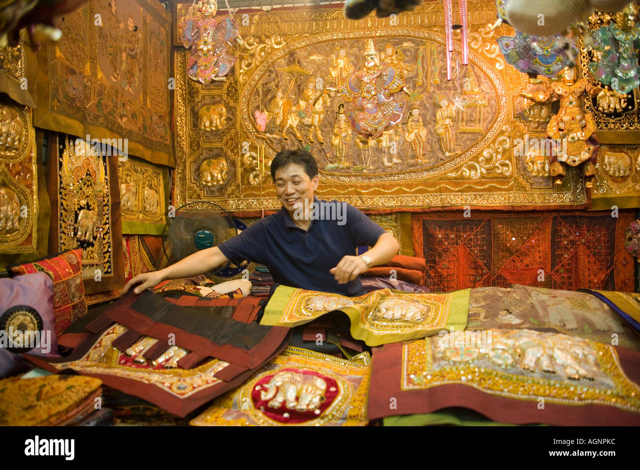 A dealer showing his goods Suan Chatuchak Weekend Market Bangkok Thailand Stock Photo