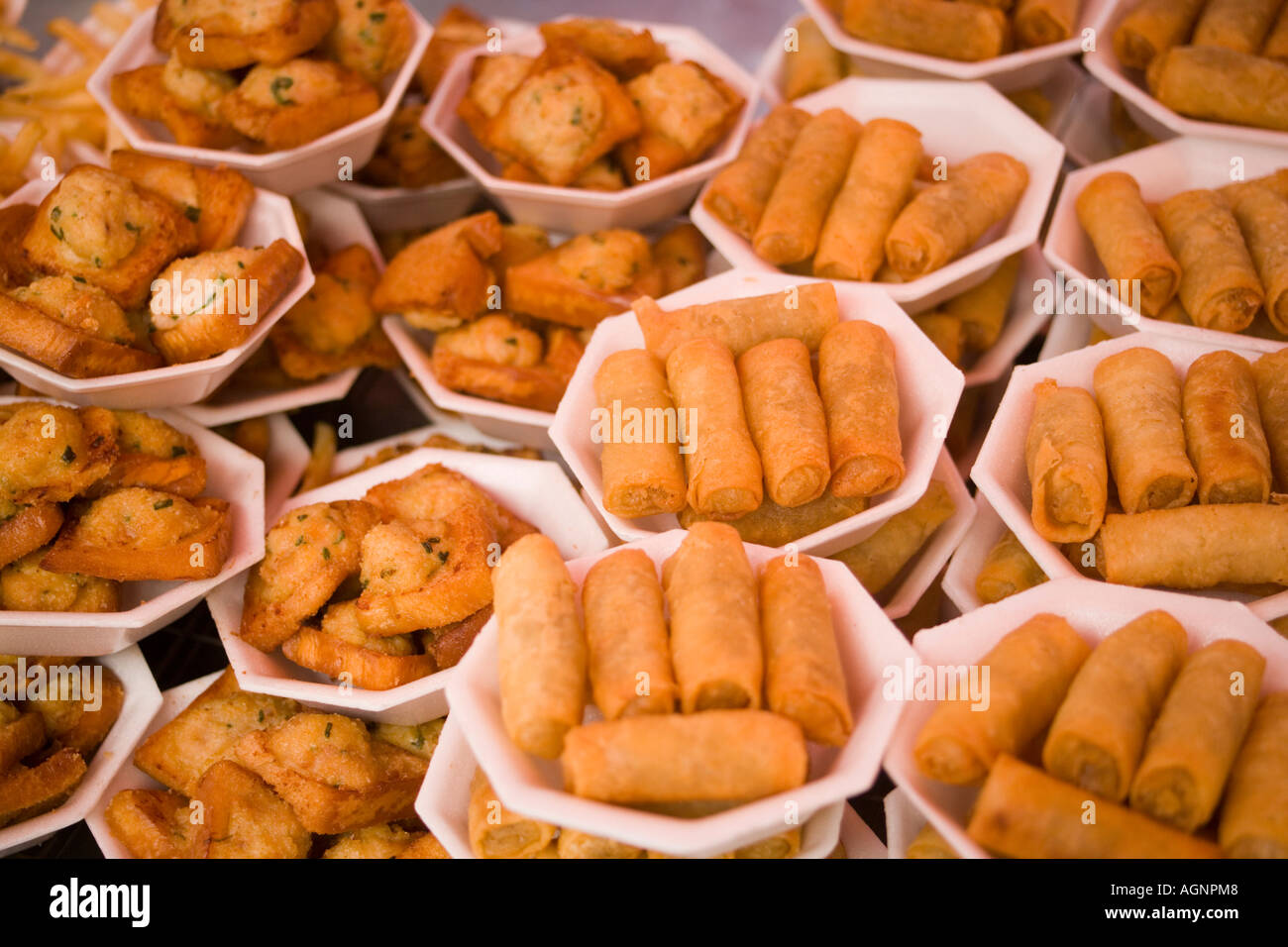 Dishes with spring rolls and Thai food offered at Suan Chatuchak Weekend Market Bangkok Thailand Stock Photo
