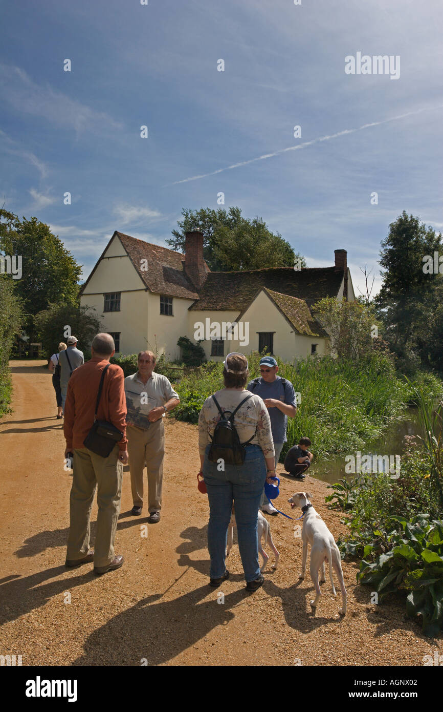 Tourists walk towards Willy Lotts cottage at Historic Flatford in Suffolk England Stock Photo