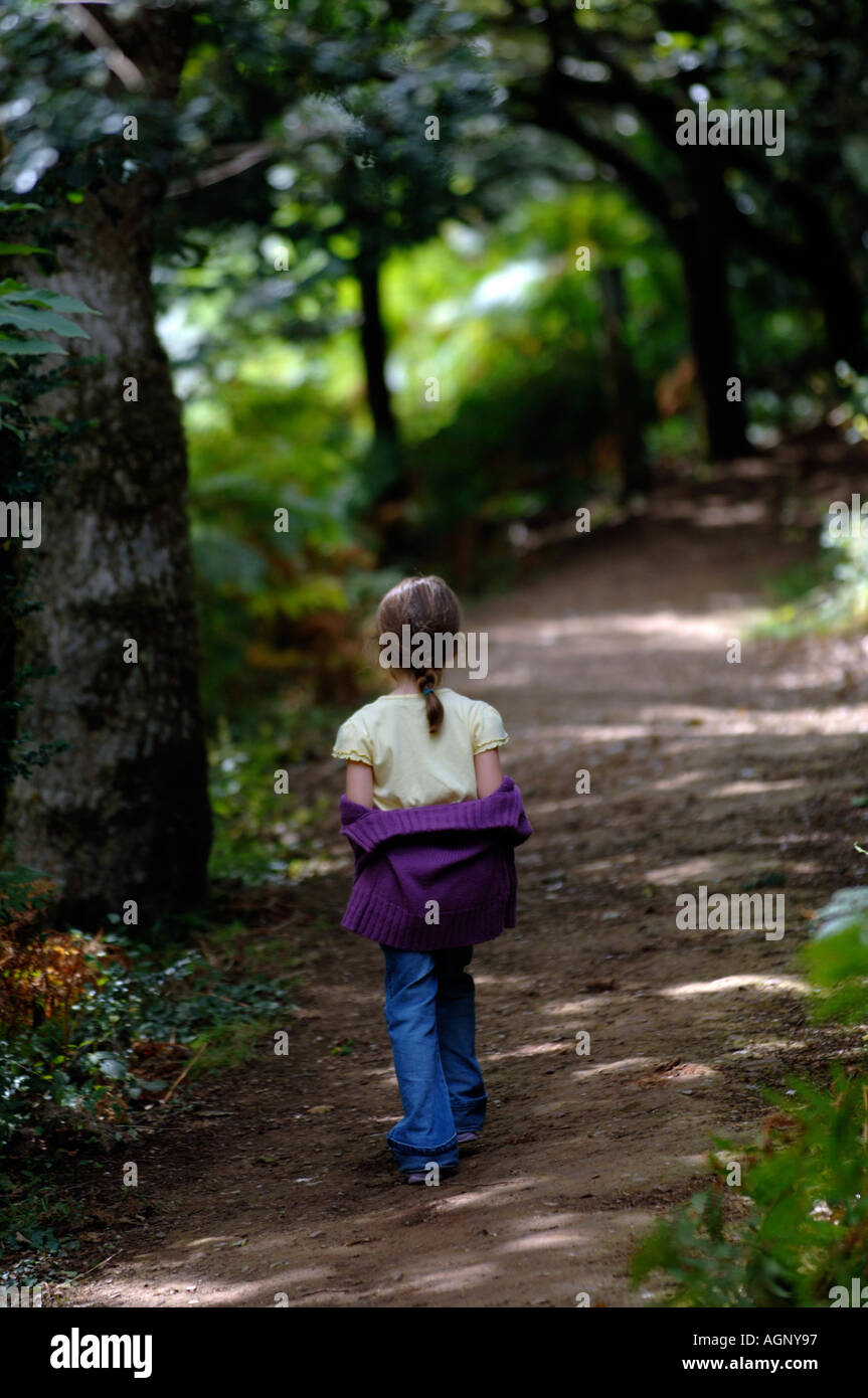 A small girl walking alone in the woods Stock Photo 4654998 Alamy