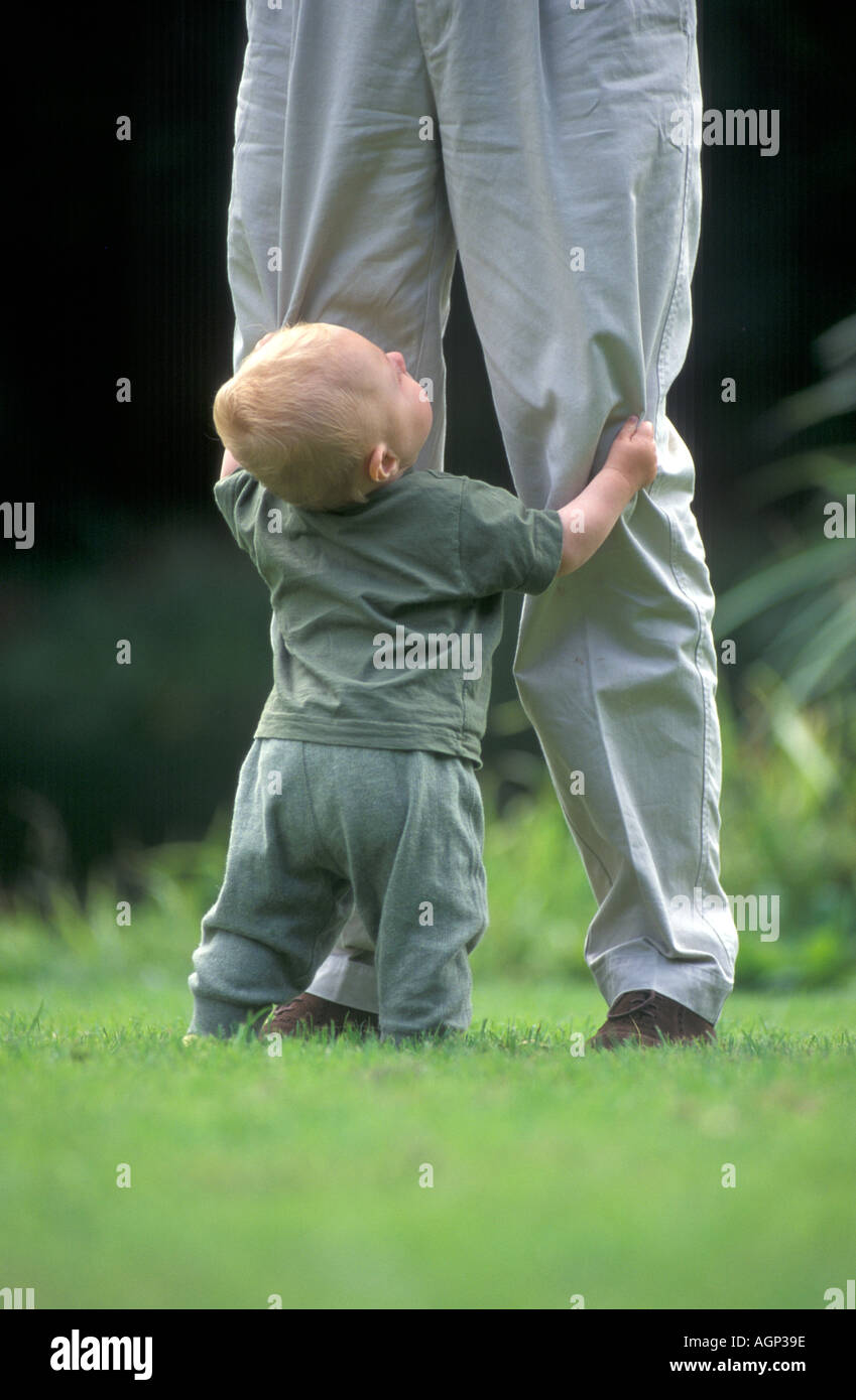 Baby with fathers long legs Stock Photo - Alamy