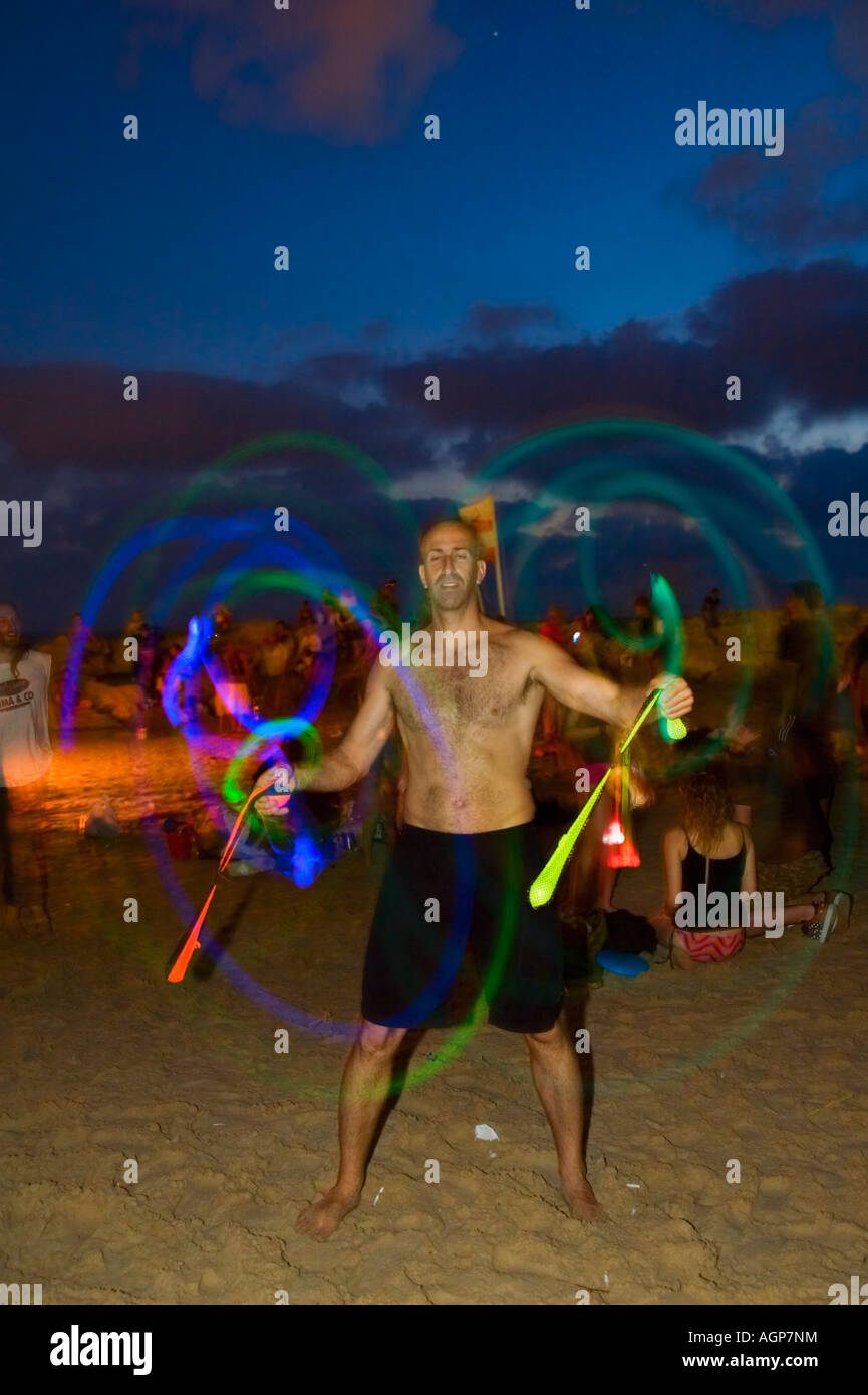 Israel Tel aviv Drum beach Young man of 20 juggling with glowing balls long exposure Stock Photo