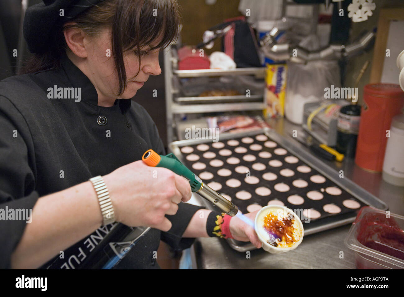 Detroit Michigan Marlene Ward pastry chef at Small Plates restaurant makes creme brulee Stock