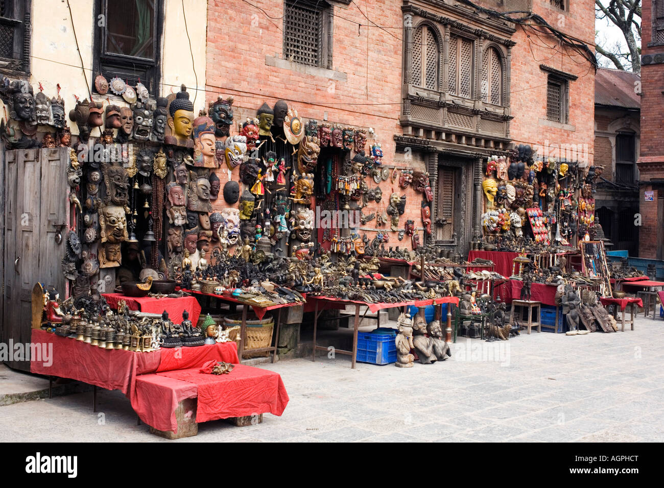 Carved wooden masks and ethnic arts outside a buddhist temple shop at