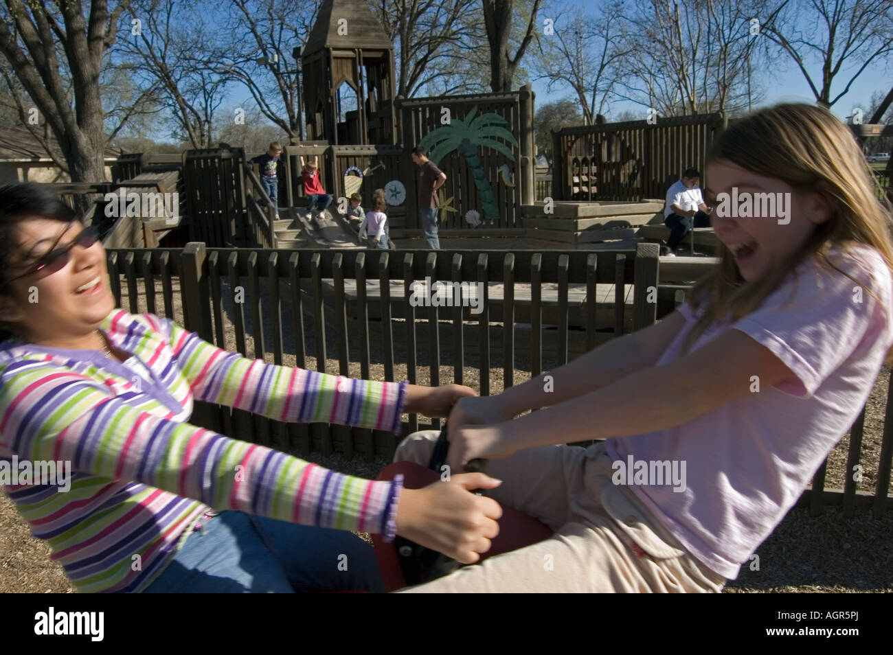 Two girls playing in a playground Stock Photo - Alamy