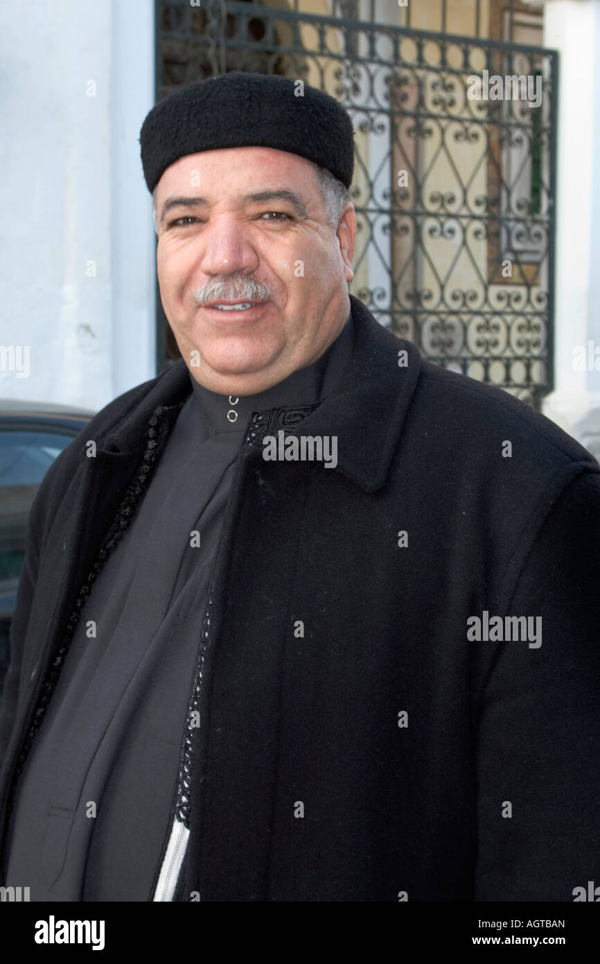 Libyan Man Wears Traditional Heavy Coat (Kaboot) After Eid Prayers plus Black Tunisian Hat, a Chechia Stock Photo