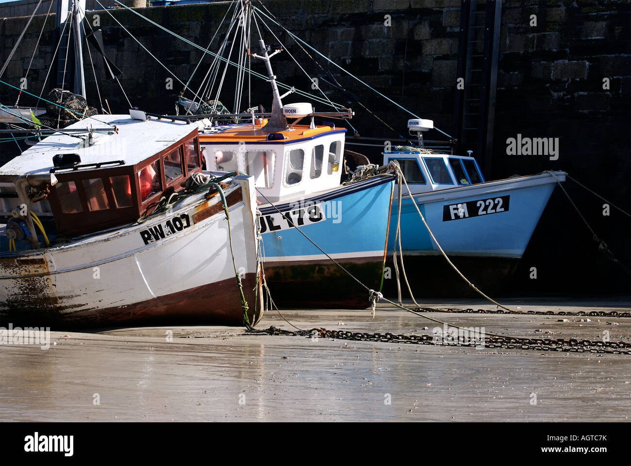 Fishing boats in Newquay harbour during low tide Stock Photo - Alamy