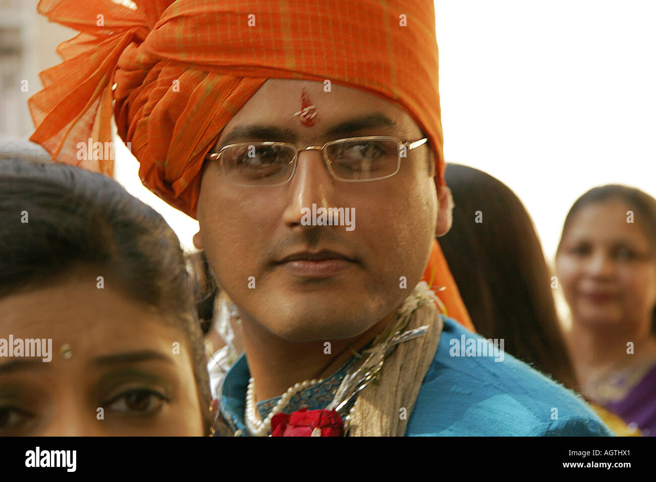 An indian gujarati groom amidst dancing relatives hires stock