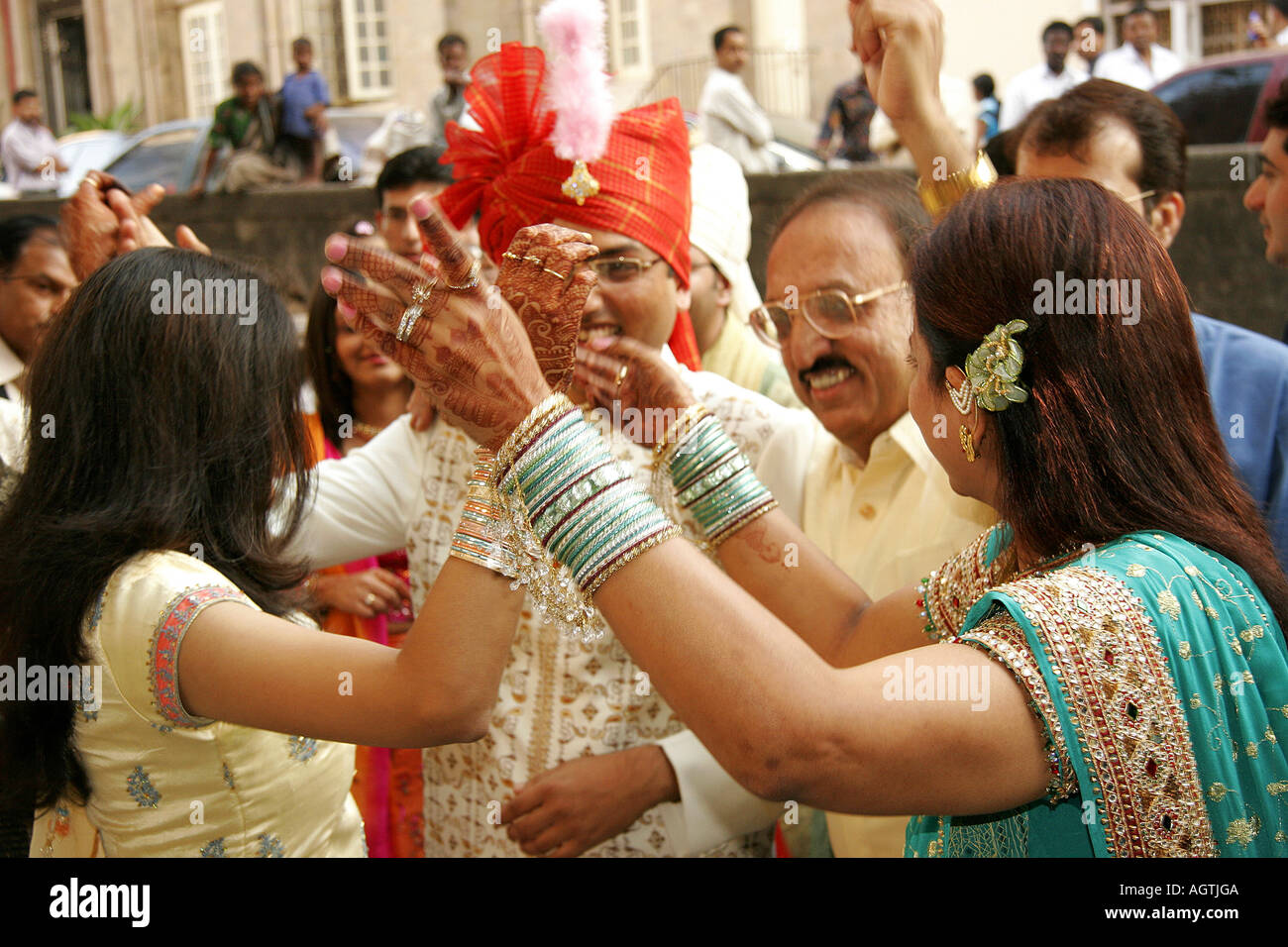SSK79510 Indian Gujarati Bridegroom amidst dancing relatives celebrating his wedding day India Model Release 667 Stock Photo