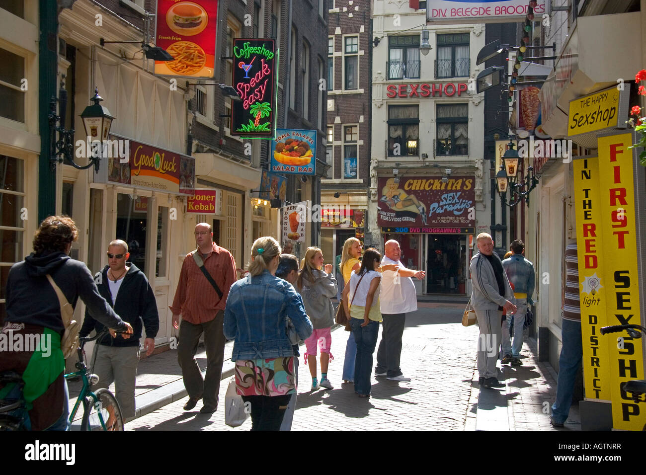 People and store fronts on a walking street in the Red Light District of  Amsterdam Netherlands Stock Photo - Alamy