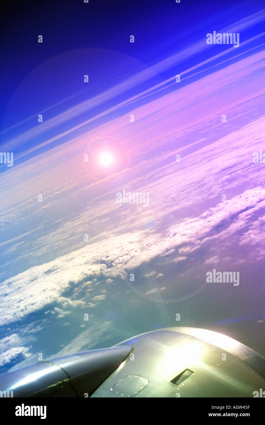 Jet Aircraft window view of sun and clouds over Europe from 30 000 feet ...
