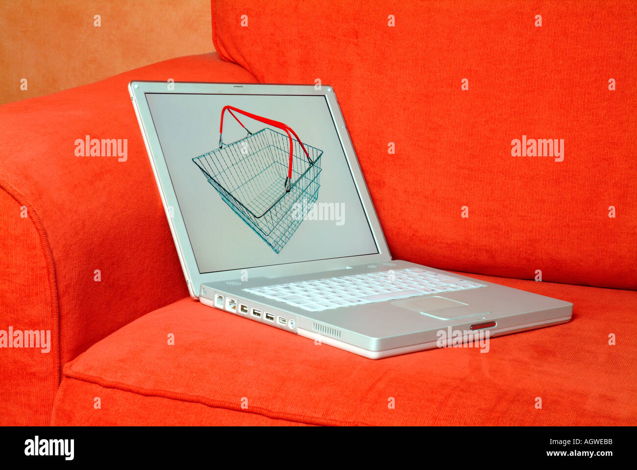 laptop computer on a red sofa Stock Photo