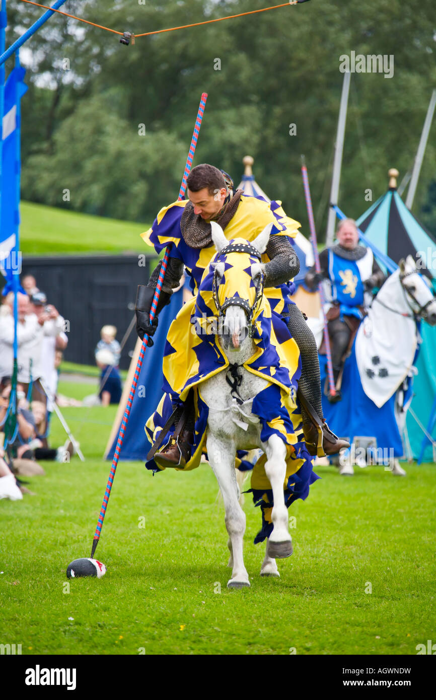 Medieval knight spearing fake severed head during reenactment tournament Stock Photo