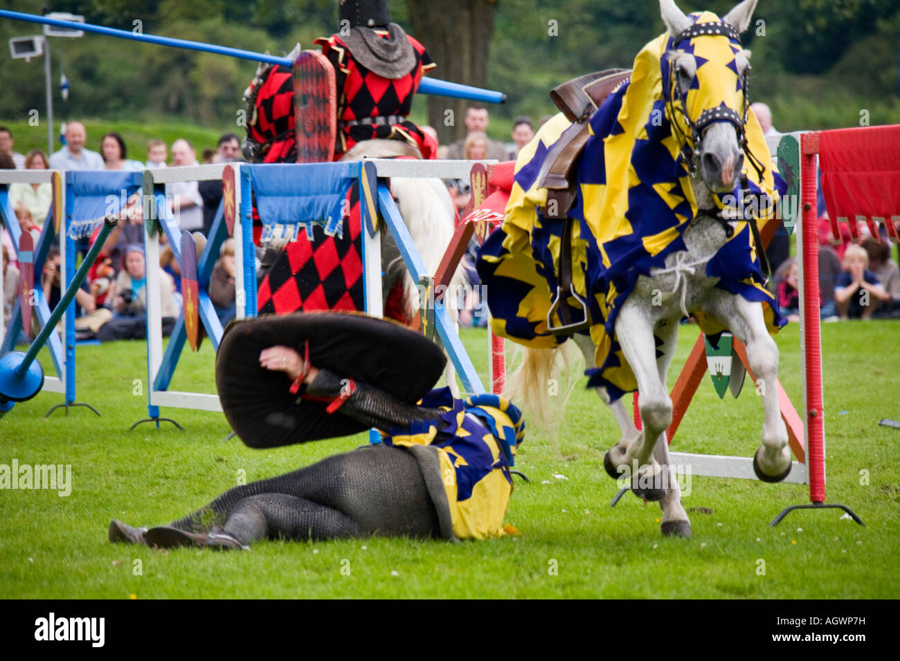Medieval knight knocked off horse during jousting tournament Stock