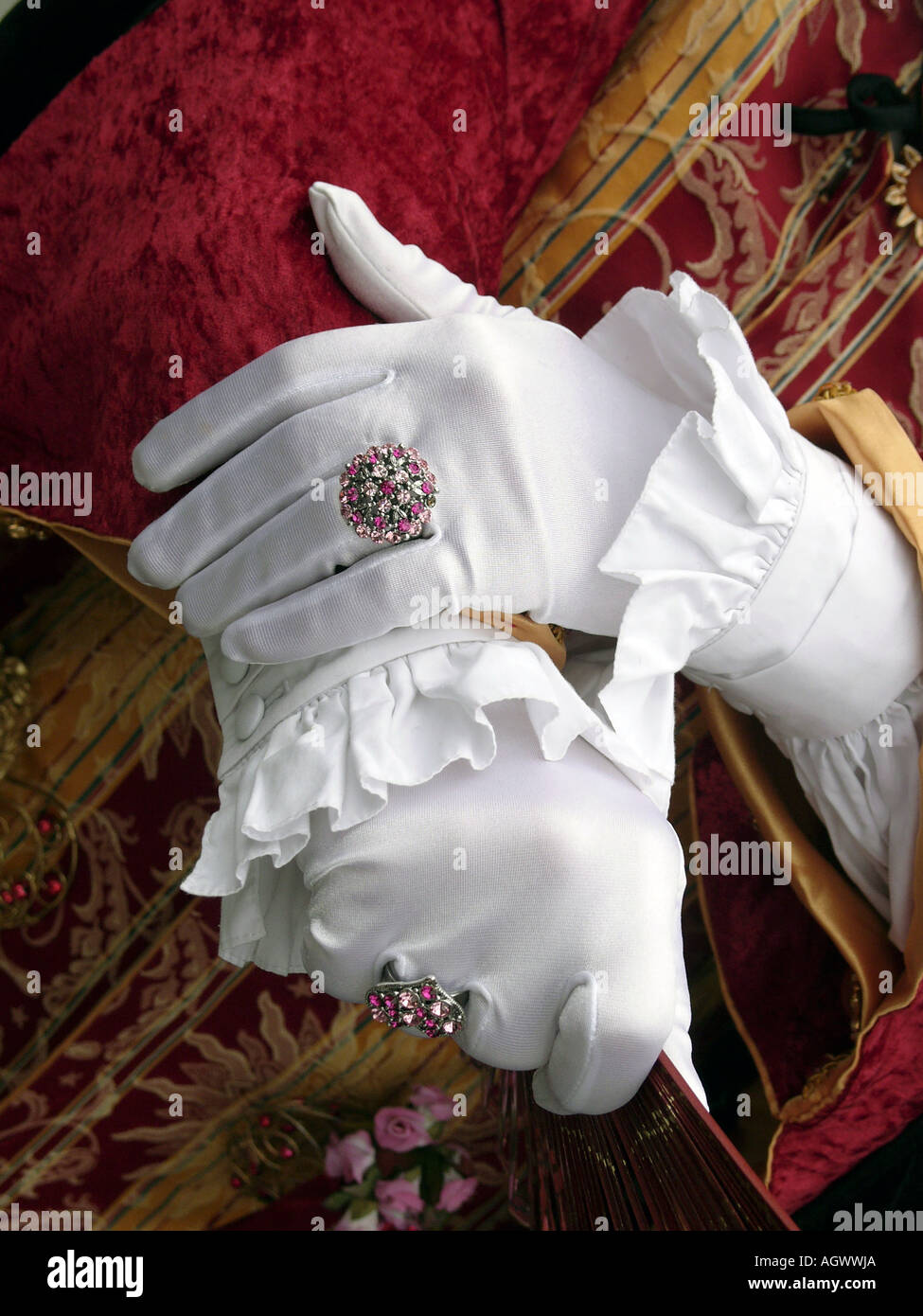 Hands in white silk gloves and large diamond rings costume at Venice Carnival Stock Photo