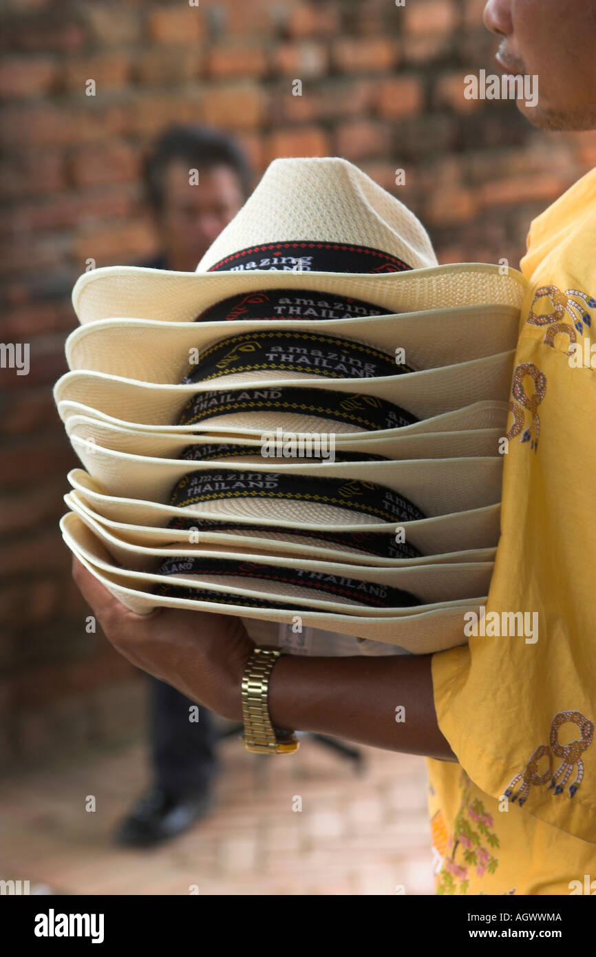 a man holding stack of amazing Thailand hats Stock Photo