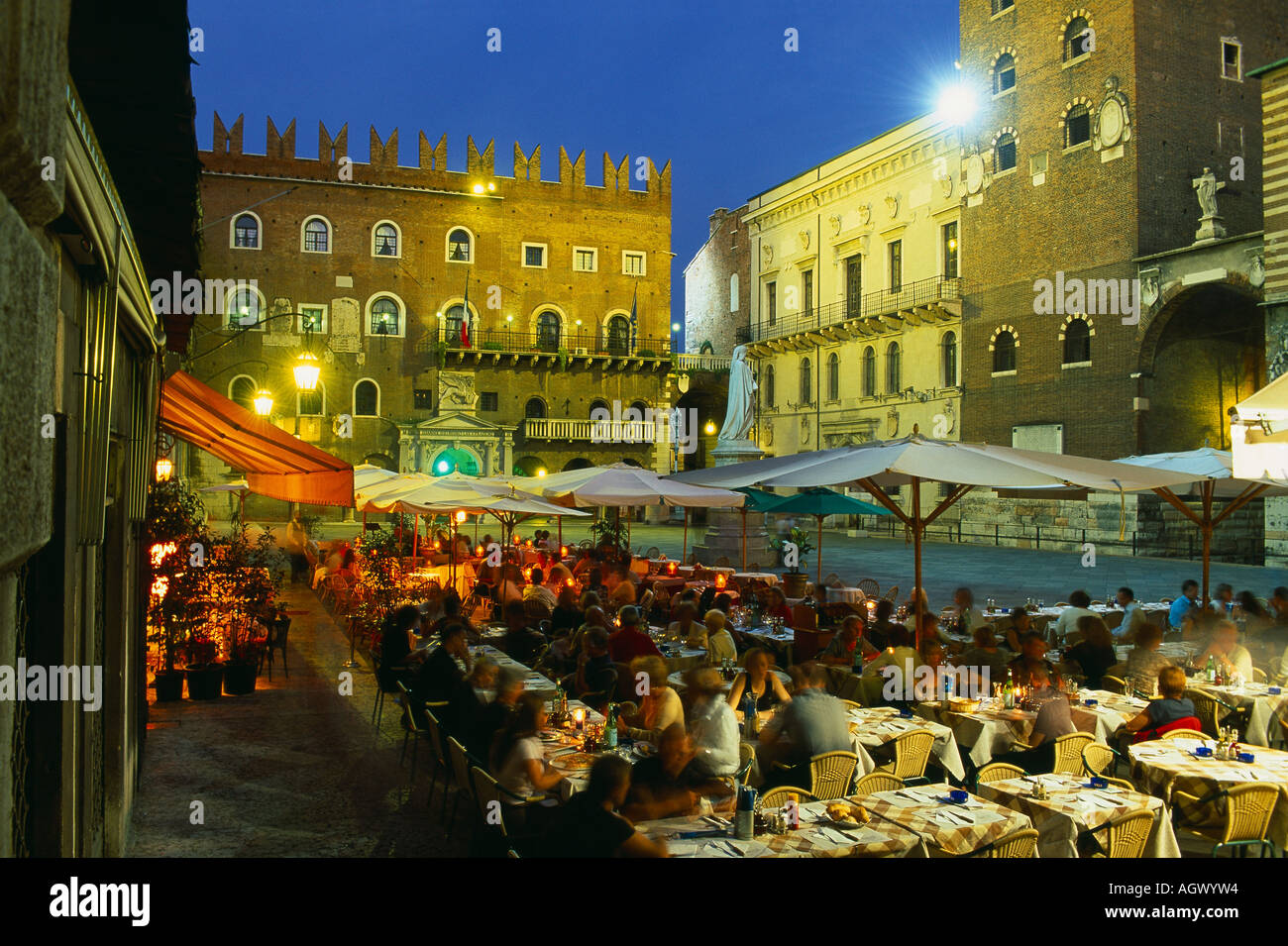 people drinking and eating in Piazza dei Signori at night Verona