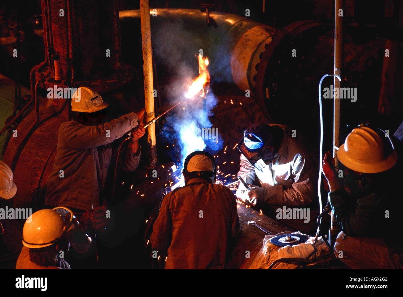 Workers welding pipes for natural gas lines in California Mojave Desert